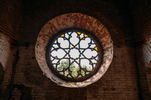 istock Round stained glass window in old abandoned castle 1256522381