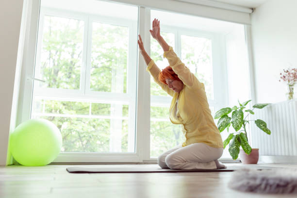 istock Senior woman practicing yoga at home 1256522841