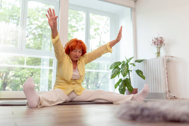 istock Elderly woman stretching out 1256523491