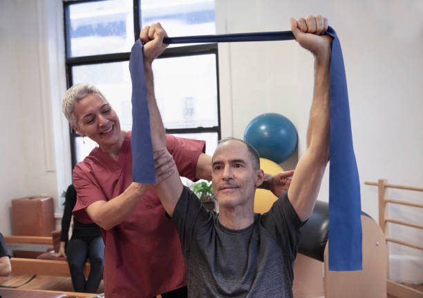 istock Senior man having shoulder pain at pilates studio 1256523810