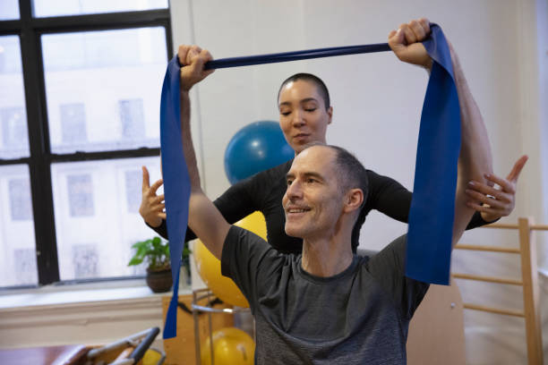 istock Senior man exercising at pilates studio 1256523854