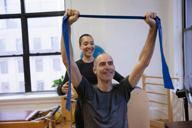 istock Senior man exercising at pilates studio 1256523928