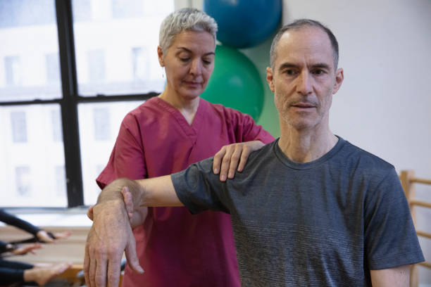 istock Senior man having shoulder pain at pilates studio 1256523969