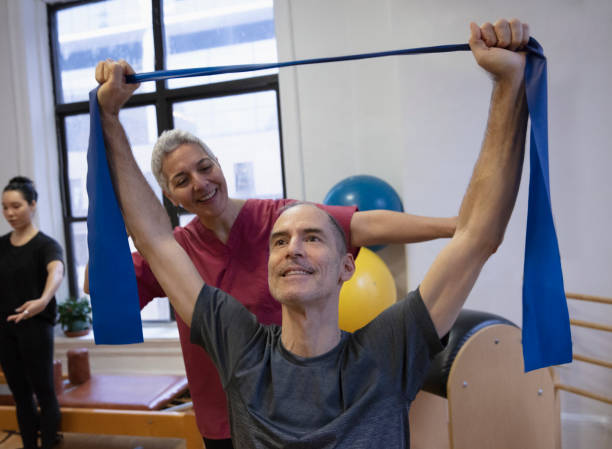 istock Senior man having shoulder pain at pilates studio 1256523992