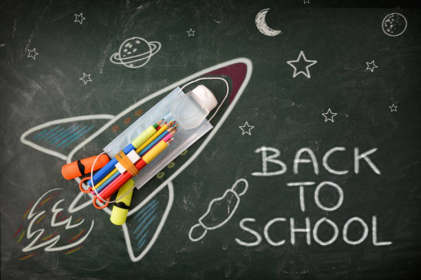School design on blackboard with tools and covid-19 protection detail School creativity with drawing on blackboard with colored pencils and covid-19 protections with back to school message. Top view back to school photos stock pictures, royalty-free photos & images