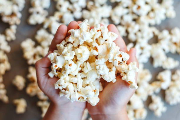 istock Popcorn in the hands of a child 1256525730