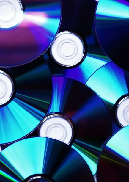 Detail of multiple CD, DVD, Blu-ray discs on pile