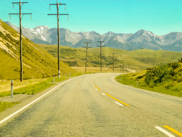 istock winding road with mountain in background 1256530396