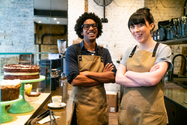 istock Two barista's in coffee shop looking at camera 1256530464