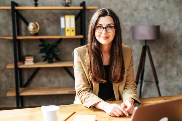 istock Young brunette successful woman sits at the table 1256533177