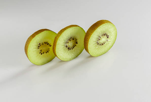 istock Kiwi sliced in three layers stand against a white background 1256533815