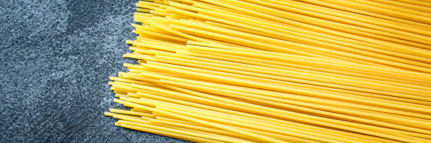 istock spaghetti pasta raw italian Menu serving size. food background top view copy space organic eating 1256535951