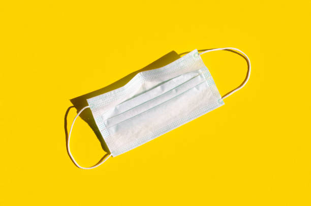 istock Medical or surgical face inside on a bright yellow background. 1256536305
