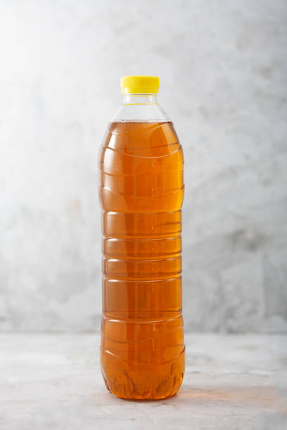 istock Bottle of ice tea, gray concrete background 1256536492