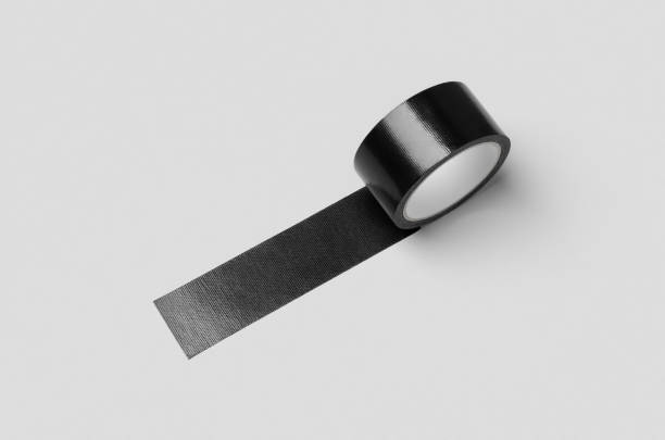 istock Black unrolled duct tape mockup on a grey background. 1256536514