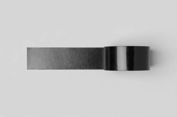 istock Black unrolled duct tape mockup on a grey background. 1256537059