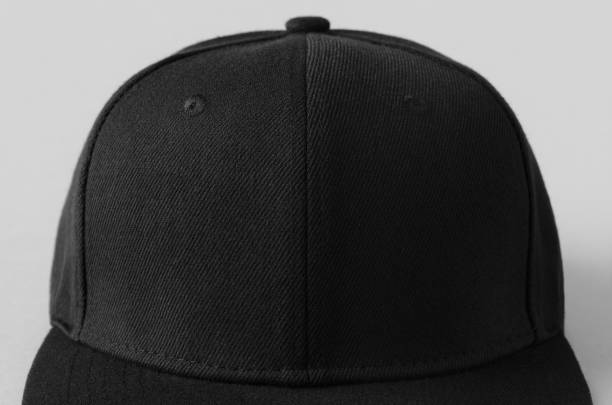 istock Black snapback cap mockup on a grey background, closeup. 1256537244