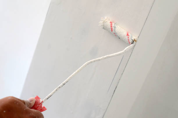 istock Painting with paint roller , wall painting concept. 1256537496