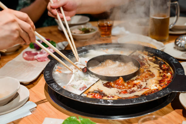 istock Eating a hot pot dish with chopsticks 1256537623