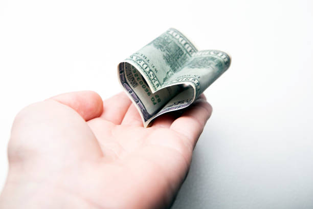 istock image of money hand white background 1256537677