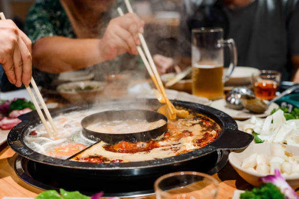 istock People cooking raw food in boiling broth 1256537689