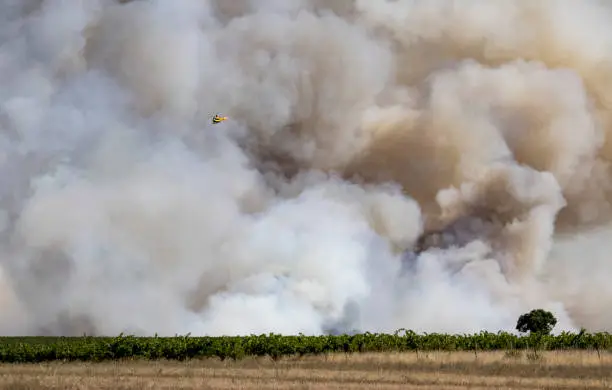 An EC145 helicopter of the French Civil Security against a major wildfire during the afternoon of August 2nd 2019, in Générac (Gard department, France).