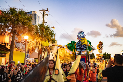 In Fort Lauderdale, United States a large paper mache puppet of a skeleton is marched during the annual Day of the Dead parade held in the downtown Riverwalk area.
