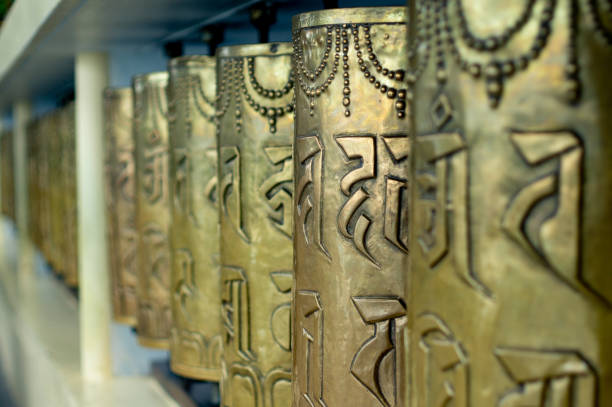 Religious copper buddhist prayer wheels with a prayer mantra written on it in a pilgamage spot in a monastary Religious copper buddhist prayer wheels with a prayer mantra written on it in a pilgamage spot in a monastary. Shot in mcleodganj, nepal,kathmandu prayer wheel nepal kathmandu buddhism stock pictures, royalty-free photos & images