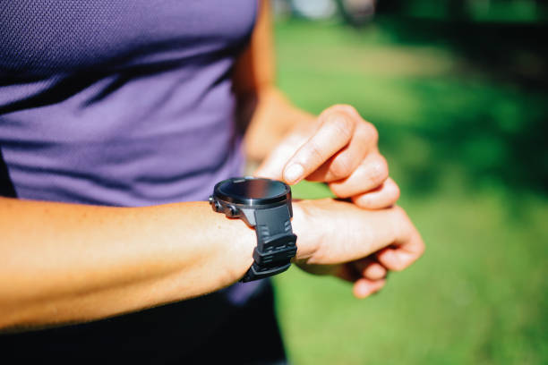 istock Female runner checking her smartwatch in the forest 1256542002