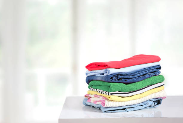 istock Stack of colorful clothes on table empty copy space,cotton clothing pile. 1256543307