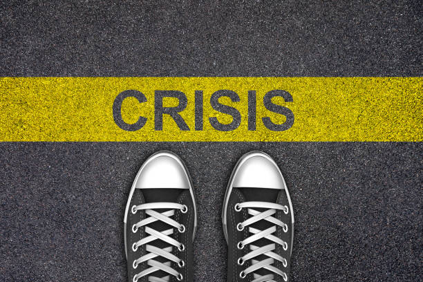 istock Crisis ahead warning road way future change 1256544881