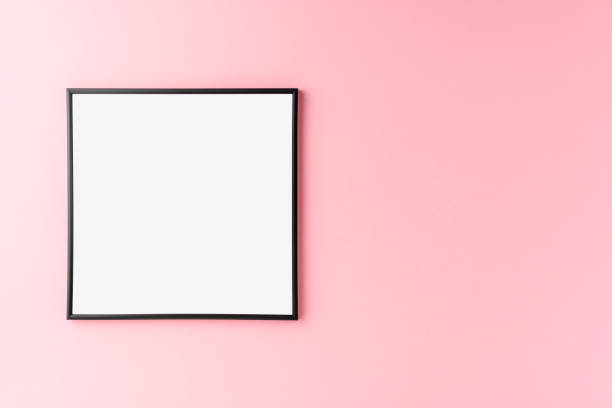 istock Black photo frame with copyspace on pink background. Home decoration 1256547151