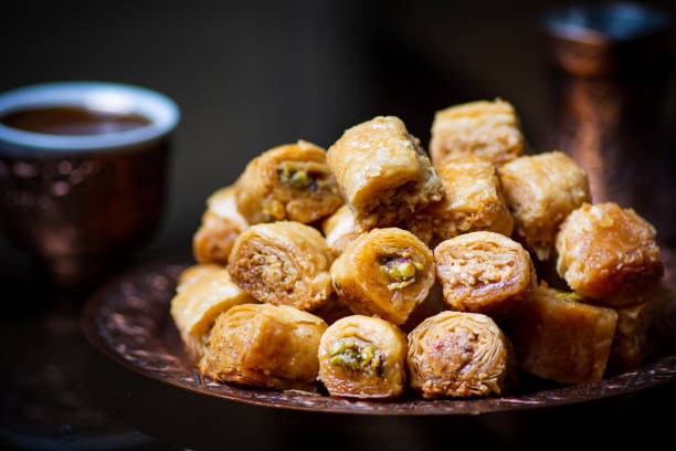istock Middle Eastern Turkish dessert with pistachio and coffee on dark background 1256548478