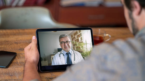 istock Doctor and patient talking on computer video call 1256548496