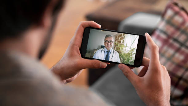 istock Doctor and patient talking on mobile phone 1256548665