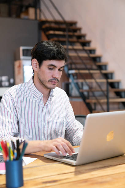 istock Young entrepreneur man working at a co-working space 1256550012