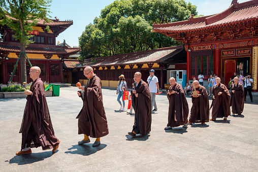 Wuxi, China – July 13, 2018: Row of Buddhist monks. Religious procession at a temple in China.