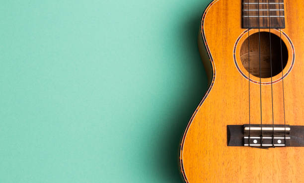 istock Closeup of ukulele on abstract turquoise background with copy space 1256551385