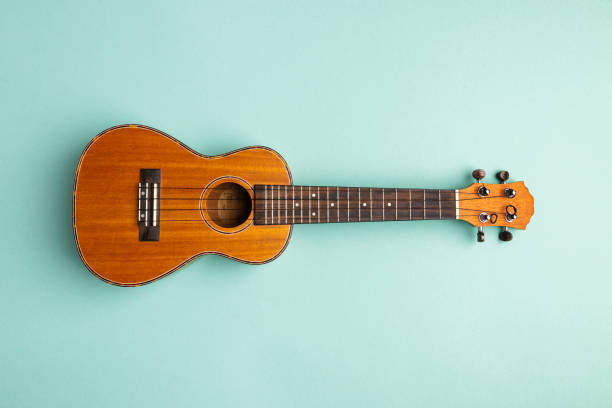 istock Ukulele isolated on abstract blue background with copy space 1256551389