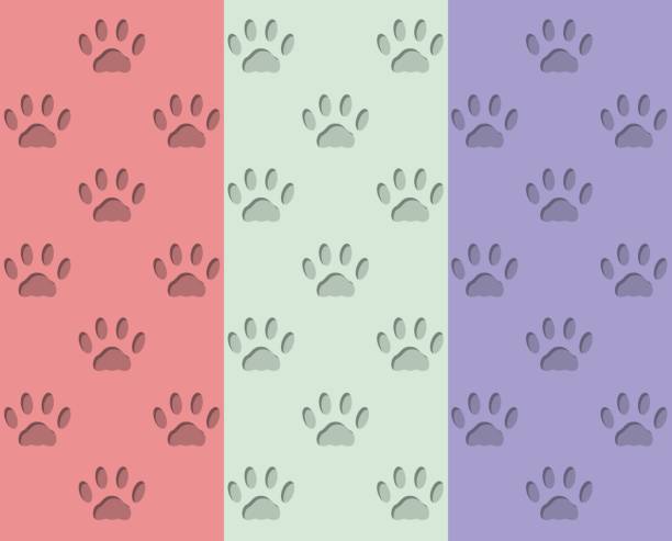 istock Endless seamless pattern of cat footprints in different colors. Volumetric concave trail of a cat on a red, green and purple background 1256552243