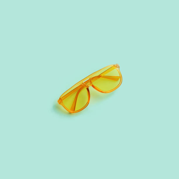 istock Yellow transparent frame trendy sunglasses on abstract mint background isolated. Copy space. Summer concept. 1256552402