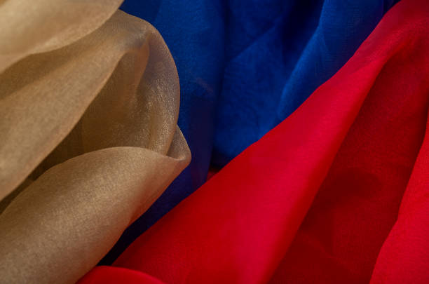 istock Silky golden red and blue fabric making a background texture 1256552736