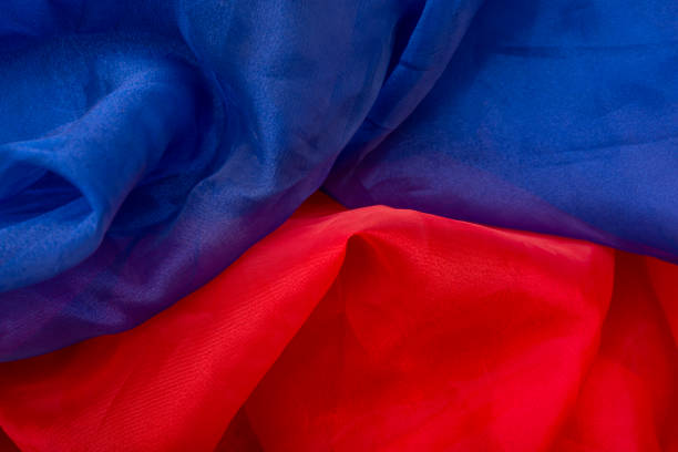istock Closeup of red and blue silk fabric making a background 1256552744