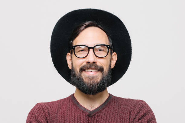 istock Happy Young Unshaved Man In Hat Isolated 1256553795