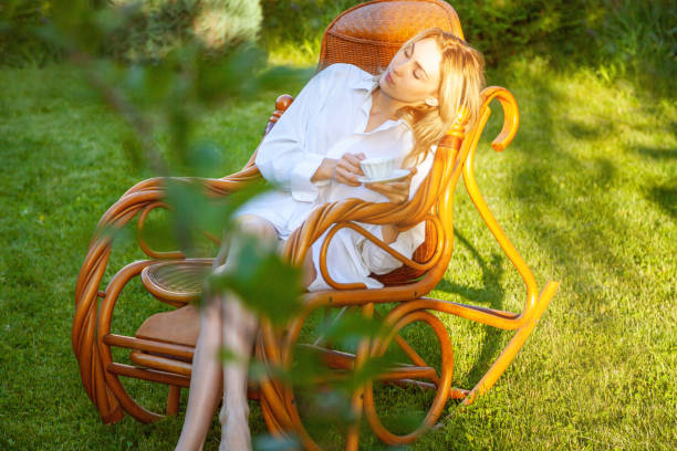 istock Young beautiful blonde woman relaxing at backyard 1256555377