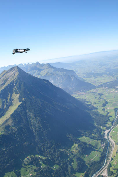 istock Man in wingsuit soars over Swiss Alps 1256555645
