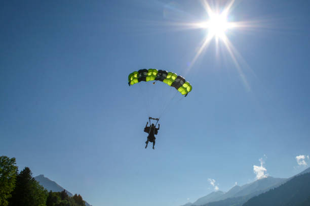 istock Paraglider soars through clear skies 1256555742
