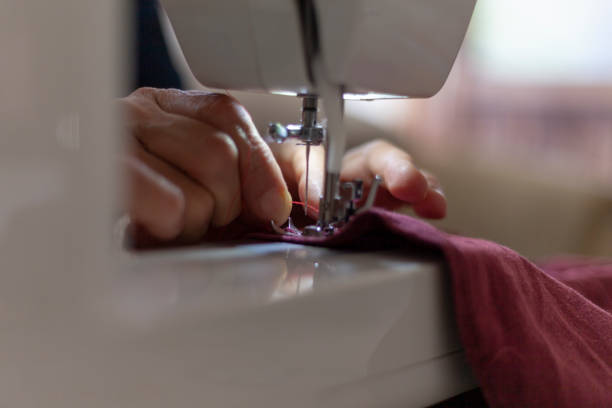 istock tailor sews fabric on the sewing machine 1256555778