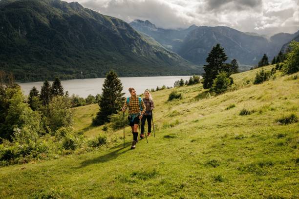 istock Young male and female trekking 1256555797