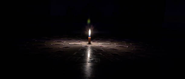 istock Candle light in dark room 1256555845